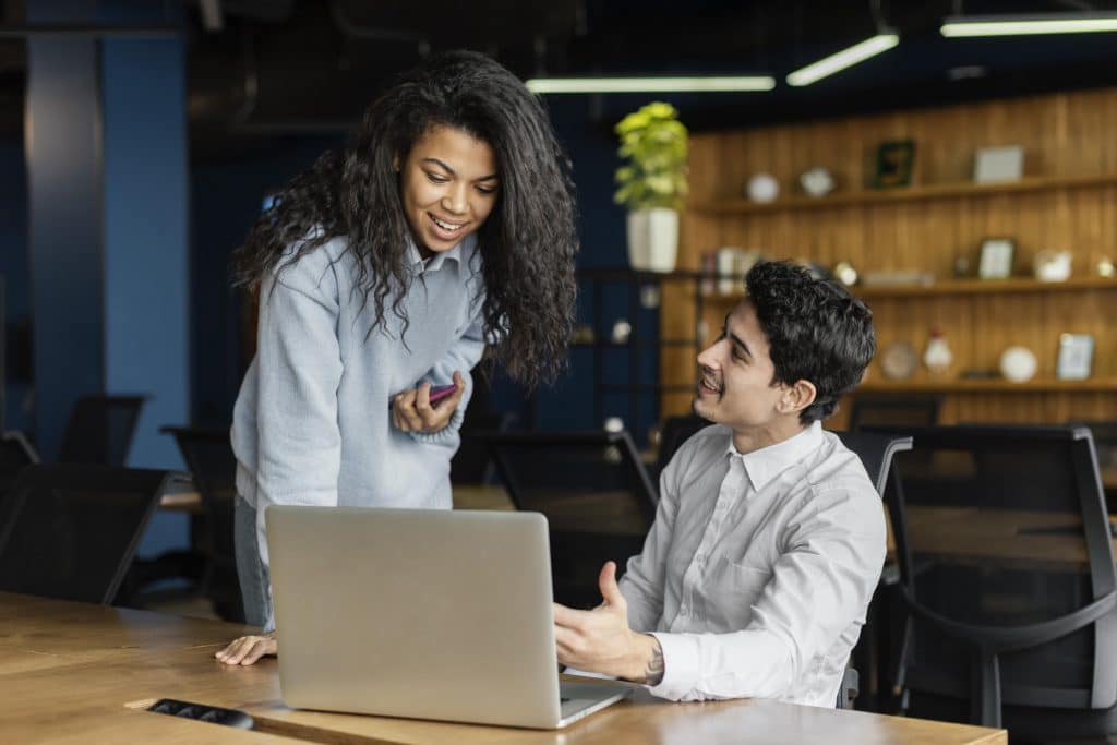 Coworkers Working Together Office With Laptop